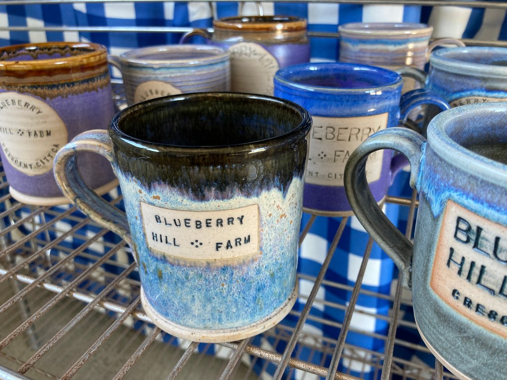 Farm stand display of mugs from Bay Studios